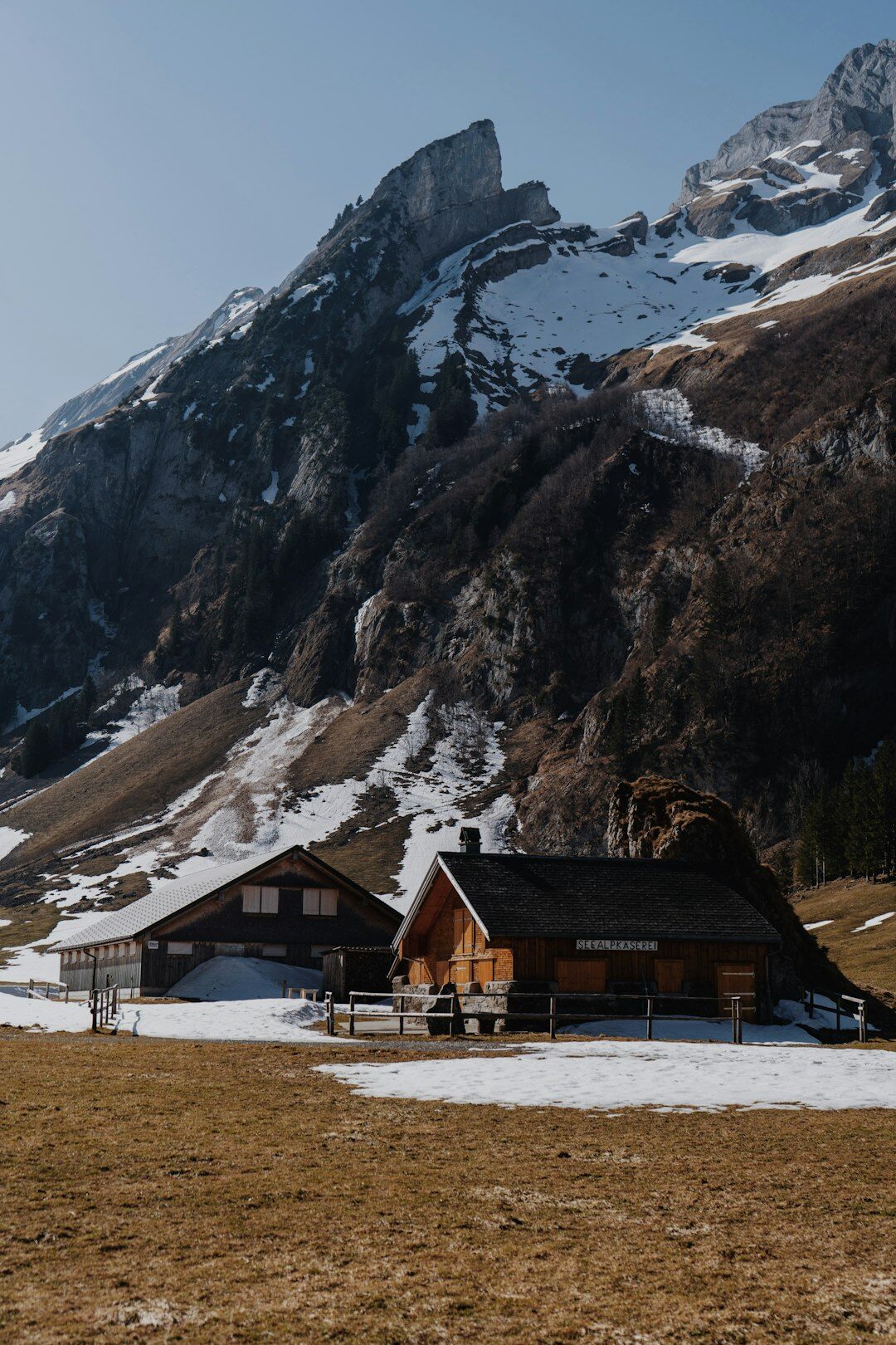 Swiss alpine chalet exterior with snow-capped mountains in the background