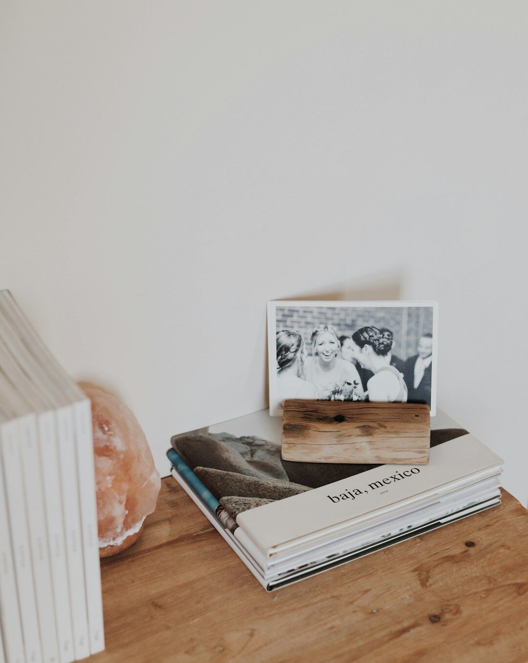 An editor's desk covered with printed photographs, magazines and a typewriter