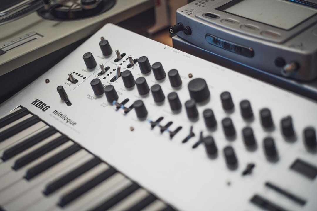 Home recording studio with a vintage mixing console and guitars on the wall