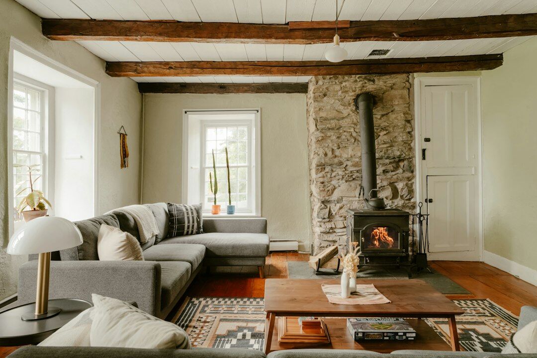 Elegant Swiss chalet living room with a stone fireplace and wooden beams